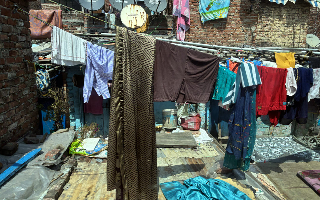 This is a picture taken from the train of people living along the tracks